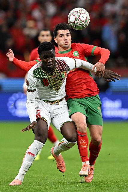 Mali's midfielder #08 Mahamadou Doumbia (L) and Morocco's forward #10 Brahim Diaz compete for the ball during the Africa Cup of Nations (CAN) Group A football match between Morocco and Mali at Prince Moulay Abdellah Stadium in Rabat on December 26, 2025. (Photo by Gabriel BOUYS / AFP)