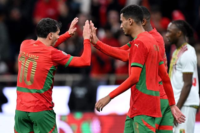 Morocco's forward #10 Brahim Diaz (L) celebrates scoring the team's first goal during the Africa Cup of Nations (CAN) Group A football match between Morocco and Mali at Prince Moulay Abdellah Stadium in Rabat on December 26, 2025. (Photo by Gabriel BOUYS / AFP)