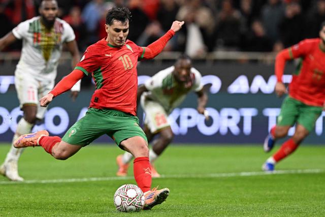 Morocco's forward #10 Brahim Diaz shoots from the penalty spot to score the team's first goal during the Africa Cup of Nations (CAN) Group A football match between Morocco and Mali at Prince Moulay Abdellah Stadium in Rabat on December 26, 2025. (Photo by Gabriel BOUYS / AFP)