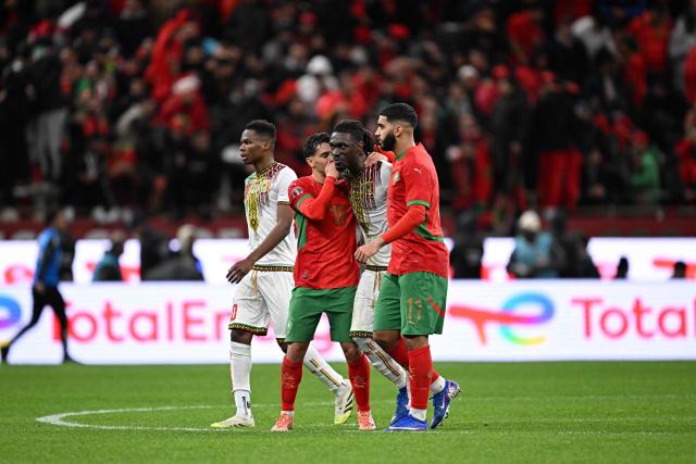 Morocco's forward #10 Brahim Diaz (2L) speaks to Mali's midfielder #10 Yves Bissouma and Morocco's midfielder #11 Ismael Saibari after the penalty during the Africa Cup of Nations (CAN) Group A football match between Morocco and Mali at Prince Moulay Abdellah Stadium in Rabat on December 26, 2025. (Photo by Gabriel BOUYS / AFP)