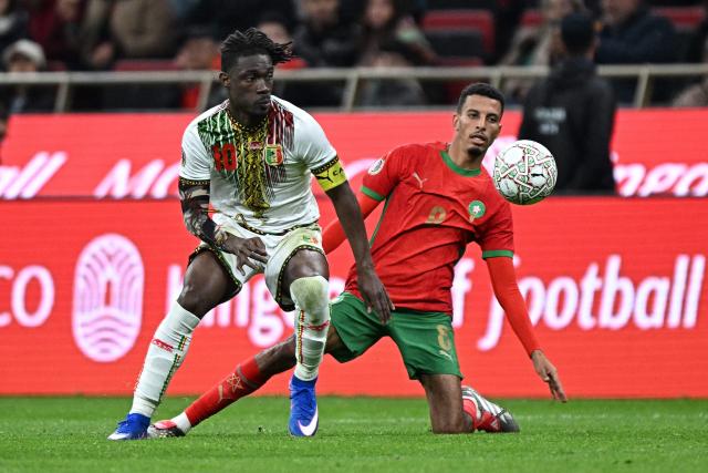 Mali's midfielder #10 Yves Bissouma gets the ball away from Morocco's midfielder #08 Azzedine Ounahi during the Africa Cup of Nations (CAN) Group A football match between Morocco and Mali at Prince Moulay Abdellah Stadium in Rabat on December 26, 2025. (Photo by Gabriel BOUYS / AFP)