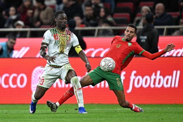 Mali's midfielder #10 Yves Bissouma gets the ball away from Morocco's midfielder #08 Azzedine Ounahi during the Africa Cup of Nations (CAN) Group A football match between Morocco and Mali at Prince Moulay Abdellah Stadium in Rabat on December 26, 2025. (Photo by Gabriel BOUYS / AFP)
