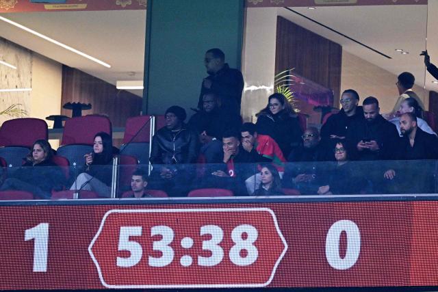 French footballer player Kylian Mbappe and French humorist, actor and producer Jamel Debbouze watch the Africa Cup of Nations (CAN) Group A football match between Morocco and Mali at Prince Moulay Abdellah Stadium in Rabat on December 26, 2025. (Photo by Gabriel BOUYS / AFP)