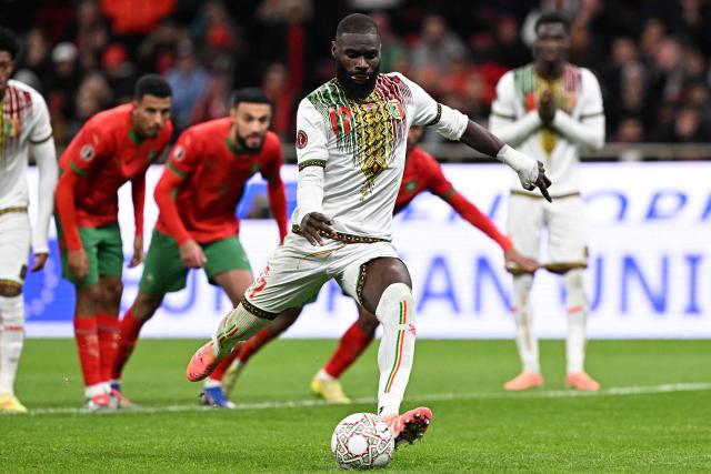 Mali's forward #17 Lassine Sinayoko scores a penalty during the Africa Cup of Nations (CAN) Group A football match between Morocco and Mali at Prince Moulay Abdellah Stadium in Rabat on December 26, 2025. (Photo by Gabriel BOUYS / AFP)