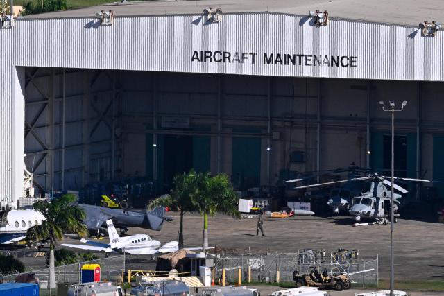 US Military working at José Aponte de la Torre Airport, formerly Roosevelt Roads Naval Station, on December 26, 2025 in Ceiba, Puerto Rico. The United States has deployed a major military force in the Caribbean and has recently intercepted oil tankers as part of a naval blockade against Venezuelan vessels it considers to be under sanctions. Since September, US forces have launched dozens of air strikes on boats that Washington alleges, without showing evidence, were transporting drugs. More than 100 people have been killed. (Photo by Miguel J. Rodriguez Carrillo / AFP)