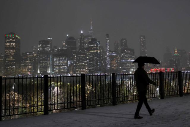 A person walks through snow on December 26, 2025 in New York City. (Photo by ANGELA WEISS / AFP)