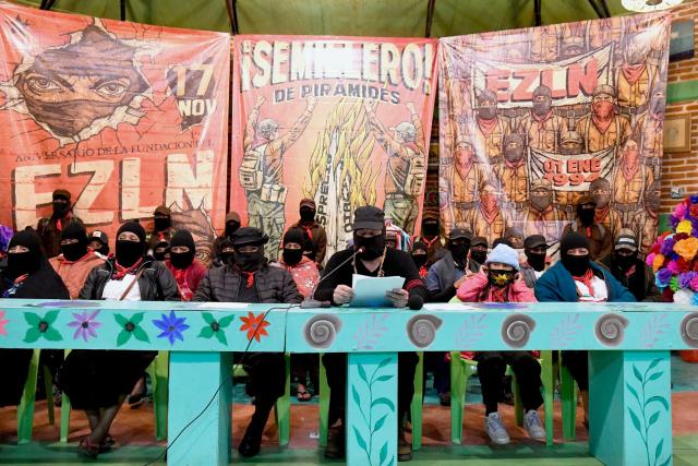 Former Subcommander, now Captain Marcos (C), next to Subcommander Moises (C-L), of the Zapatista Army of National Liberation (EZLN in Spanish), delivers a welcoming message to the meeting called “Of Pyramids, of Histories, of Loves and Heartbreaks” in the framework of the 32nd anniversary of his armed uprising in 1994, in the city of San Cristobal de las Casas, state of Chiapas, Mexico, on December 26, 2025. (Photo by Isaac GUZMAN / AFP)