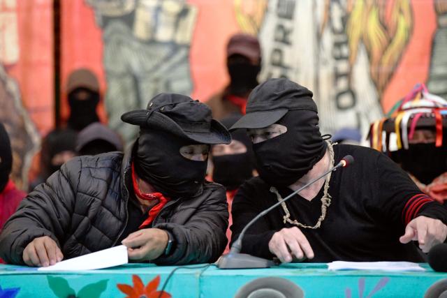 Former Subcommander, now Captain Marcos (R), and Subcommander Moises, of the Zapatista Army of National Liberation (EZLN in Spanish), talk during the meeting called “Of Pyramids, of Histories, of Loves and Heartbreaks” in the framework of the 32nd anniversary of his armed uprising in 1994, in the city of San Cristobal de las Casas, state of Chiapas, Mexico, on December 26, 2025. (Photo by Isaac GUZMAN / AFP)