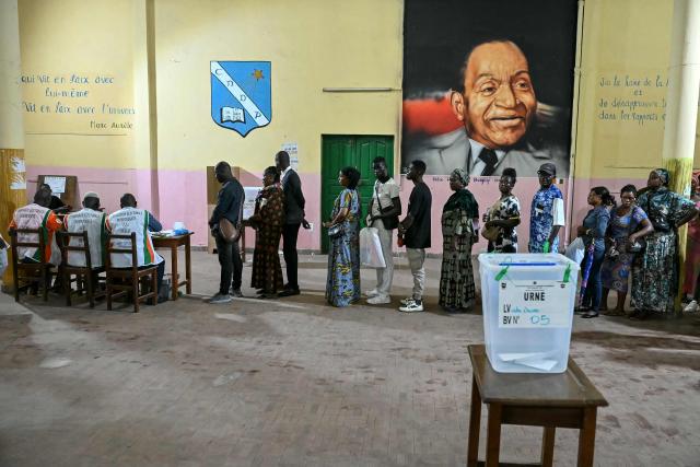 Voters queue at a polling station in Abidjan on December 27, 2025 during Ivory Coast's legislative elections. (Photo by SIA KAMBOU / AFP)