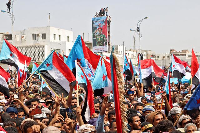 (FILES) Yemeni Southern separatists supporters wave flags of the former South Yemen (The People's Democratic Republic of Yemen) as they demonstrate in the Khor Maksar district of Yemen's second city of Aden on August 15, 2019. Saudi Arabia warned on December 27, 2025 it would back Yemen's government in any military confrontation with separatist forces and urged them to withdraw "peacefully" from recently-seized provinces. In recent weeks, separatists backed by the United Arab Emirates and seeking to revive the formerly independent state of South Yemen have made territorial gains. (Photo by Nabil HASAN / AFP)