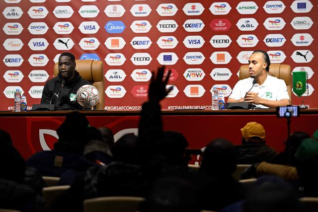 Ivory Coast's head coach Emerse Fee (L) and Ivory Coast's defender #17 Guela Doue attend a press conference in Marrakesh, on December 27, 2025, on the eve of the 2025 Africa Cup of Nations (CAN) football match between Cameroon and Ivory Coast. (Photo by Khaled DESOUKI / AFP)