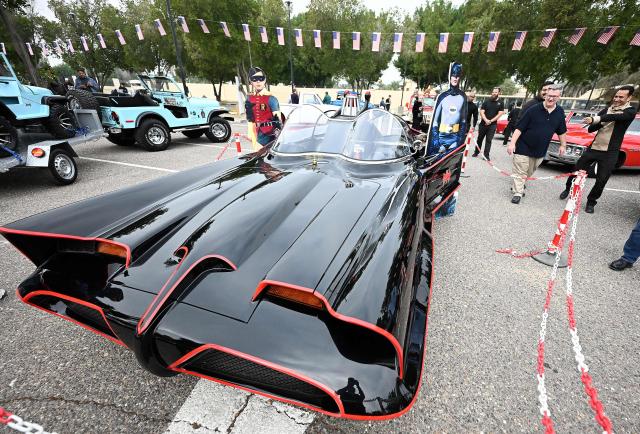 Charge d'Affaires at the US Embassy in Kuwait Steven Butler (2R) tours the Cars and Coffee Celebration of America exhibition held at the US Embassy in Kuwait City on December 27, 2025. The exhibition showcased a number of classic and modern American vehicles. (Photo by YASSER AL-ZAYYAT / AFP)