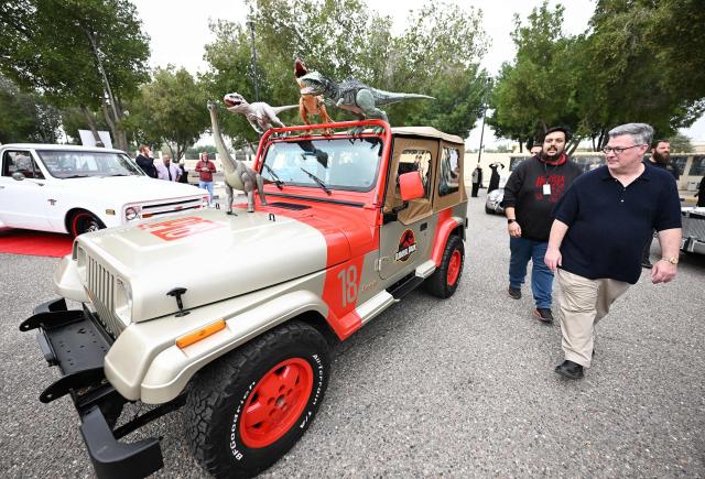 Charge d'Affaires at the US Embassy in Kuwait Steven Butler (R) tours the Cars and Coffee Celebration of America exhibition held at the US Embassy in Kuwait City on December 27, 2025. The exhibition showcased a number of classic and modern American vehicles. (Photo by YASSER AL-ZAYYAT / AFP)