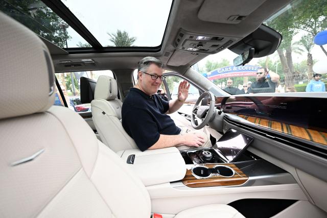 Charge d'Affaires at the US Embassy in Kuwait Steven Butler tours the Cars and Coffee Celebration of America exhibition held at the US Embassy in Kuwait City on December 27, 2025. The exhibition showcased a number of classic and modern American vehicles. (Photo by YASSER AL-ZAYYAT / AFP)