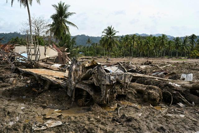 Debris from houses and vehicles remains piled up at an area that was devastated by flash floods in Aek Garoga Village, South Tapanuli, North Sumatra, on December 27, 2025. (Photo by YT Hariono / AFP)