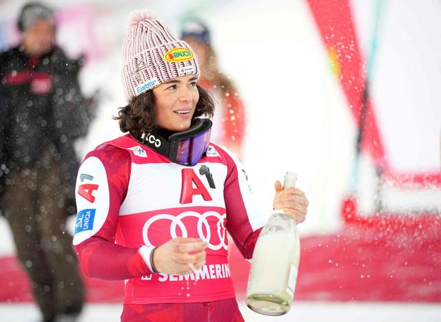 Winner Austria's Julia Scheib celebrates on the podium with champagne after the women's giant slalom event of the FIS Alpine Ski World Cup in Semmering, Austria on December 27, 2025. (Photo by GEORG HOCHMUTH / APA / AFP) / Austria OUT