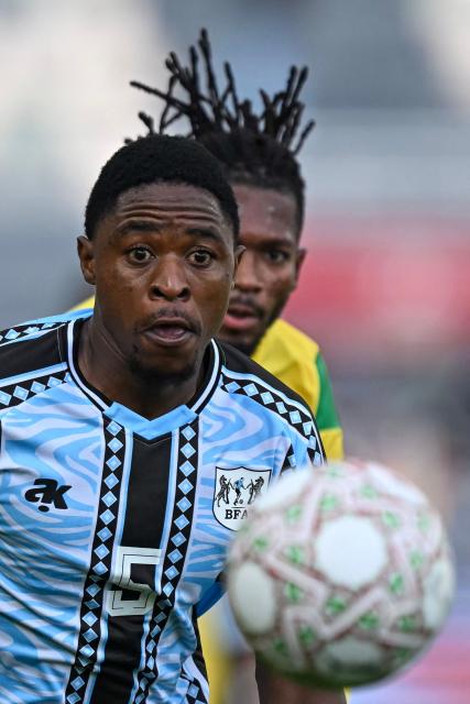 TOPSHOT - Botswana's defender #05 Alford Velaphi and Benin's midfielder #08 Imourane Hassane vie during the Africa Cup of Nations (CAN) Group D football match between Benin and Botswana at Rabat Olympic Stadium in Rabat on December 27, 2025. (Photo by Paul ELLIS / AFP)
