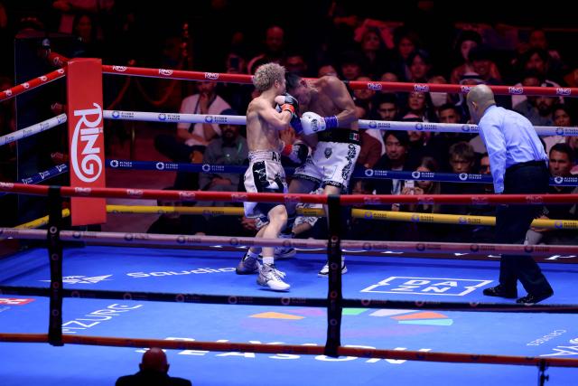 Japan's boxer Naoya Inoue (L) fights Mexico's boxer David Picasso in the "The Ring V night of Samurai" final major fight card of the year at the Mohammed Abdo Arena in Riyadh on December 27, 2025. (Photo by Fayez NURELDINE / AFP)