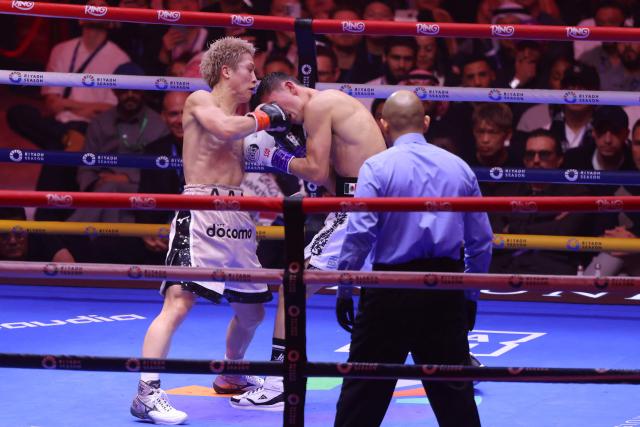 Japan's boxer Naoya Inoue (L) fights Mexico's boxer David Picasso in the "The Ring V night of Samurai" final major fight card of the year at the Mohammed Abdo Arena in Riyadh on December 27, 2025. (Photo by Fayez NURELDINE / AFP)
