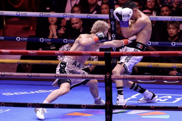 Japan's boxer Naoya Inoue (L) fights Mexico's boxer David Picasso in the "The Ring V night of Samurai" final major fight card of the year at the Mohammed Abdo Arena in Riyadh on December 27, 2025. (Photo by Fayez NURELDINE / AFP)