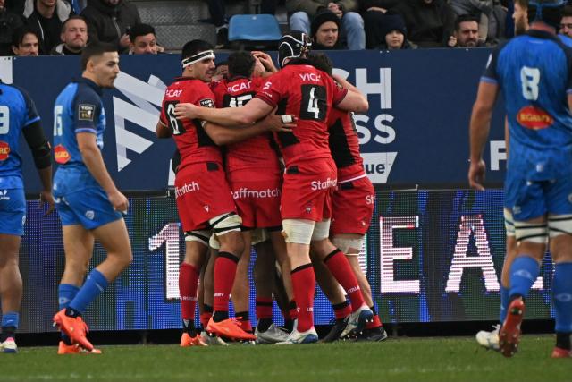Lou's players celebrate after scoring a try during the French Top 14 rugby union match between Castres Olympique and Lyon Olympique Universitaire Rugby (LOU) at Stade Pierre Fabre in Castres, southern France, on December 27, 2025. (Photo by Matthieu RONDEL / AFP)