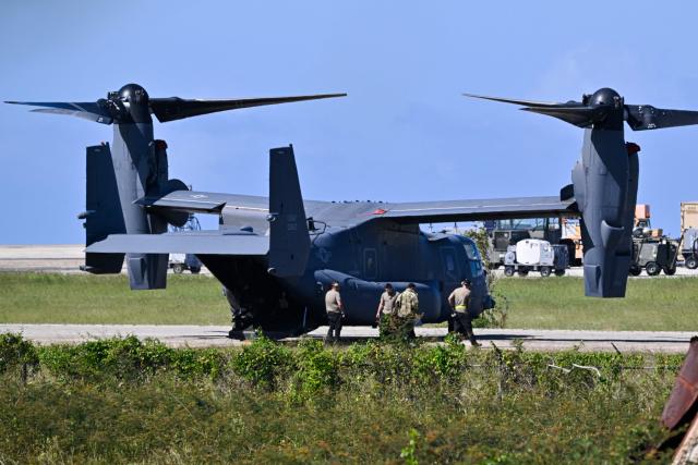 US military MQ-9 Reaper drones sit on a tarmac at Rafael Hernandez Airport in Aguadilla, Puerto Rico, on December 27, 2025. The United States has deployed a major military force in the Caribbean and has recently intercepted oil tankers as part of a naval blockade against Venezuelan vessels it considers to be under sanctions. Since September, US forces have launched dozens of air strikes on boats that Washington alleges, without showing evidence, were transporting drugs. More than 100 people have been killed. (Photo by Miguel J. Rodriguez Carrillo / AFP)
