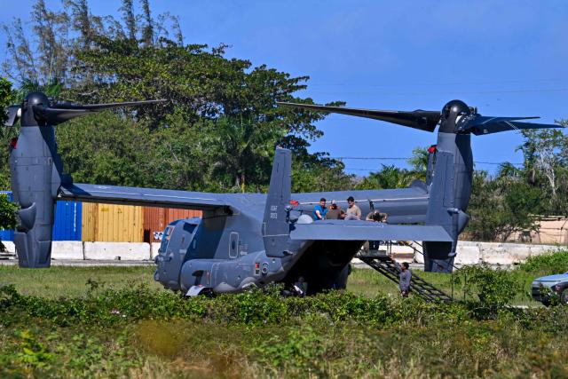 US military MQ-9 Reaper drones sit on a tarmac at Rafael Hernandez Airport in Aguadilla, Puerto Rico, on December 27, 2025. The United States has deployed a major military force in the Caribbean and has recently intercepted oil tankers as part of a naval blockade against Venezuelan vessels it considers to be under sanctions. Since September, US forces have launched dozens of air strikes on boats that Washington alleges, without showing evidence, were transporting drugs. More than 100 people have been killed. (Photo by Miguel J. Rodriguez Carrillo / AFP)