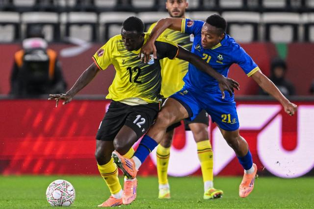 Uganda's midfielder #12 Baba Alhassan and Tanzania's forward #21 Kelvin John vie during the Africa Cup of Nations (CAN) Group C football match between Uganda and Tanzania at Al Medina Stadium in Rabat on December 27, 2025. (Photo by SEBASTIEN BOZON / AFP)