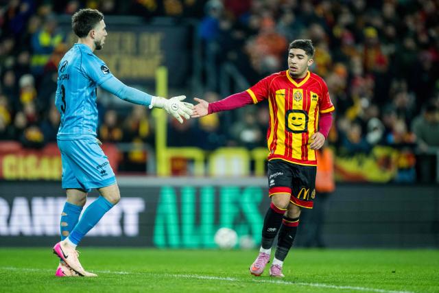 Mechelen' Spanish goalkeeper #13 Nacho Miras (L) and Mechelen's Moroccan defender #23 Moncef Zekri greet each other during the Belgian "Pro League" First Division football match between KV Mechelen and FCV Dender EH at the Achter De Kazerne Stadium in Mechelen on December 27, 2025. (Photo by JASPER JACOBS / BELGA / AFP) / Belgium OUT