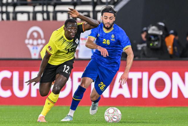 Uganda's midfielder #12 Baba Alhassan and Tanzania's midfielder #26 Tarryn Allarakhia vie during the Africa Cup of Nations (CAN) Group C football match between Uganda and Tanzania at Al Medina Stadium in Rabat on December 27, 2025. (Photo by SEBASTIEN BOZON / AFP)