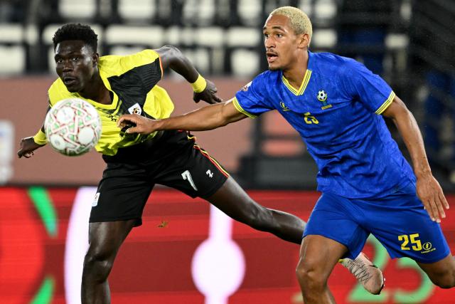 Uganda's forward #07 Rogers Mato and Tanzania's midfielder #25 Haji Mnoga vie during the Africa Cup of Nations (CAN) Group C football match between Uganda and Tanzania at Al Medina Stadium in Rabat on December 27, 2025. (Photo by SEBASTIEN BOZON / AFP)