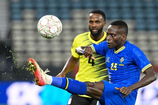 Uganda's defender #04 Kenneth Semakula and Tanzania's defender #15 Mohamed Hussein vie during the Africa Cup of Nations (CAN) Group C football match between Uganda and Tanzania at Al Medina Stadium in Rabat on December 27, 2025. (Photo by SEBASTIEN BOZON / AFP)