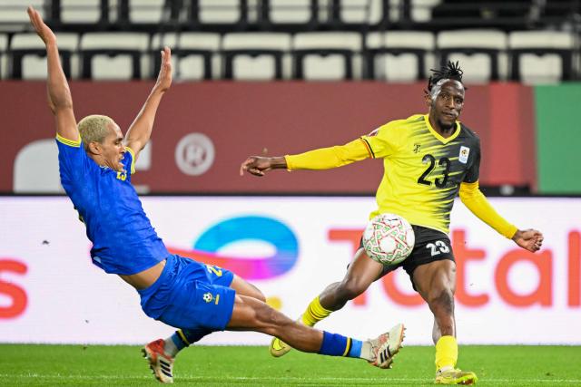 Tanzania's midfielder #25 Haji Mnoga and Uganda's defender #23 Aziz Kayondo vie during the Africa Cup of Nations (CAN) Group C football match between Uganda and Tanzania at Al Medina Stadium in Rabat on December 27, 2025. (Photo by SEBASTIEN BOZON / AFP)