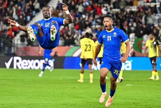 Tanzania's forward #12 Simon Msuva celebrates his goal with Tanzania's forward #21 Kelvin John during the Africa Cup of Nations (CAN) Group C football match between Uganda and Tanzania at Al Medina Stadium in Rabat on December 27, 2025. (Photo by SEBASTIEN BOZON / AFP)