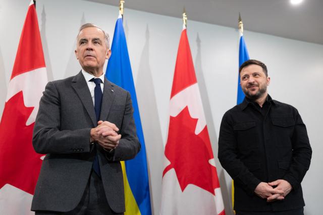 TOPSHOT - Canadian Prime Minister Mark Carney and Ukrainian President Volodymyr Zelensky speak to the press as they meet in Halifax, Nova Scotia, Canada, on December 27, 2025. Establishing a lasting peace in Ukraine requires "a willing Russia," Carney said Saturday, denouncing the "barbarism" of Moscow's latest bombardment of Kyiv as he met with  Zelensky. (Photo by Riley Smith / POOL / AFP)