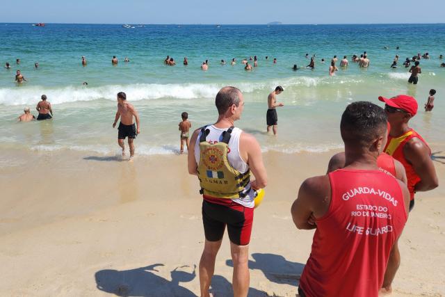Firefighters take part in a rescue operation after a small private plane fell into the ocean at Copacabana beach, in the south zone of Rio de Janeiro, Brazil on December 27, 2025. (Photo by BRUNO KAIUCA / AFP)
