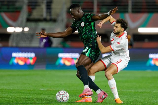 Nigeria's forward #22 Akor Adams and Tunisia's defender #03 Montassar Talbi vie during the Africa Cup of Nations (CAN) Group C football match between Nigeria and Tunisia at Fez Stadium in Fez on December 27, 2025. (Photo by Abdel Majid BZIOUAT / AFP)