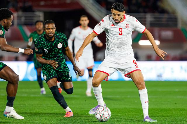 Nigeria's midfielder #08 Frank Onyeka and Tunisia's forward #09 Hazem Mastouri vie during the Africa Cup of Nations (CAN) Group C football match between Nigeria and Tunisia at Fez Stadium in Fez on December 27, 2025. (Photo by Abdel Majid BZIOUAT / AFP)