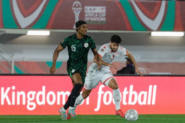 Nigeria's defender #13 Bruno Onyemaechi and Tunisia's forward #09 Hazem Mastouri vie during the Africa Cup of Nations (CAN) Group C football match between Nigeria and Tunisia at Fez Stadium in Fez on December 27, 2025. (Photo by Abdel Majid BZIOUAT / AFP)