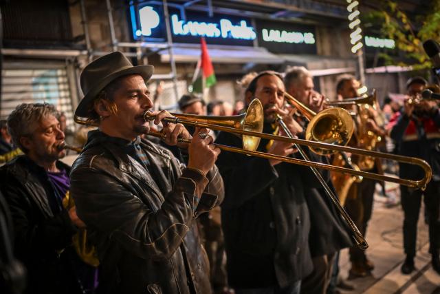 Actors and members of the artistic community perform as they take part in a demonstration during a 24-hour strike of the Greek actors' union in Athens on December 27, 2025. Most theatres were closed in Greece on during one of their busiest time of the year as actors seeking better pay went on strike for the second time this month. (Photo by Aris MESSINIS / AFP)