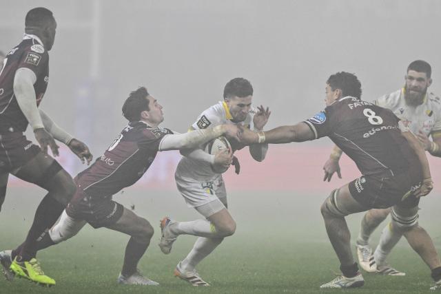 Clermont's French scrum-half Sebastien Bezy (C) is tackled by Bordeaux-Begles' French flanker Temo Matiu (2R) and Bordeaux-Begles' French fly-half Joseph Carbery (2L) during the French Top14 rugby union match between ASM Clermont Auvergne and Union Bordeaux-Begles (UBB) at the Marcel-Michelin Stadium in Clermont-Ferrand, central France on December 27, 2025. Clermont’s French scrum-half #20 Sebastien Bezy (C) is tackled by Bordeaux-Begles’ French flanker #08 Temo Matiu (R) and Bordeaux-Begles’ French fly-half #10 Joseph Carbery (L) during the Top 14 rugby union match between ASM Clermont Auvergne and Union Bordeaux Begles (UBB) at the Marcel-Michelin Stadium in Clermont-Ferrand, central France, on December 27, 2025.  JEFF PACHOUD / (Photo by JEFF PACHOUD / AFP)