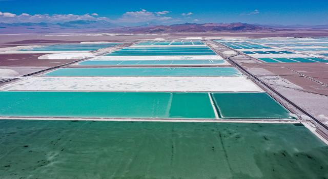 (FILES) Aerial view of brine ponds and processing areas of the lithium mine of the Chilean company SQM (Sociedad Quimica Minera) in the Atacama Desert, Calama, Chile, on September 12, 2022. On December 27, 2025, Chilean state-owned company Codelco, the world's leading copper producer, and private mining company SQM announced the creation of a giant company for lithium mining in Chile, the country with the largest reserves of this metal, which is key to the energy transition. (Photo by Martin BERNETTI / AFP)