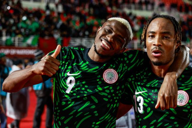 Nigeria's forward #09 Victor Osimhen celebrates with Nigeria's defender #13 Bruno Onyemaechi after the Africa Cup of Nations (CAN) Group C football match between Nigeria and Tunisia at Fez Stadium in Fez on December 27, 2025. (Photo by Abdel Majid BZIOUAT / AFP)