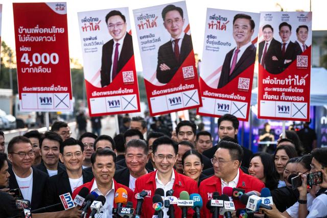 Pheu Thai Party candidate Yodchanan Wongsawat (C) speaks to the press as he arrives for the first day of the constituencies candidates registration for the upcoming general election, in Bangkok on December 28, 2025. (Photo by Chanakarn Laosarakham / AFP)
