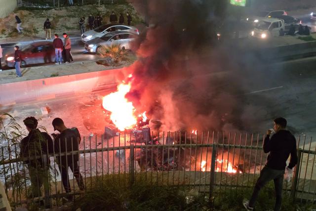 Protesters block a street with burning tires during a demonstration against Prime Minister Abdulhamid Dbeibah’s internationally recognised Government of National Unity (GNU) in Tripoli on December 27, 2025. (Photo by POOL / AFP)