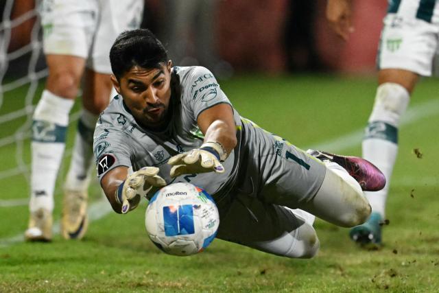 Antigua´s goalkeper #01 Luis Moran stops the ball during the Guatemalan Apertura tournament final second-leg football match between Municipal and Antigua at El Trebol Stadium in Guatemala City on December 27, 2025. (Photo by JOHAN ORDONEZ / AFP)