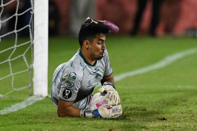 Antigua´s goalkeper #01 Luis Moran stops the ball during the Guatemalan Apertura tournament final second-leg football match between Municipal and Antigua at El Trebol Stadium in Guatemala City on December 27, 2025. (Photo by JOHAN ORDONEZ / AFP)