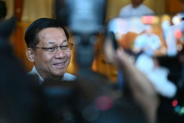 Myanmar's junta chief Min Aung Hlaing speaks to the press before casting his vote at a polling station during the first phase of Myanmar's general election in Naypyidaw on December 28, 2025. (Photo by Sai Aung MAIN / AFP)
