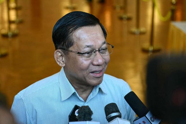 Myanmar's junta chief Min Aung Hlaing speaks to the press after voting at a polling station during the first phase of Myanmar's general election in Naypyidaw on December 28, 2025. (Photo by Sai Aung MAIN / AFP)