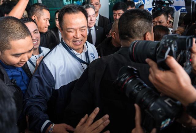 Thailand's Prime Minister and Bhumjaithai Party candidate Anutin Charnvirakul leaves after the constituencies candidates registration for the upcoming general election, in Bangkok on December 28, 2025. (Photo by Chanakarn Laosarakham / AFP)